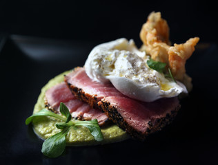 Tuna Steak with burrata mozzarella cheese,courgette flowers, laid on zucchini sauce.