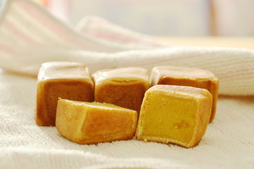 Chinese dice pasty stuffed mush sweet bean half cut on cloth