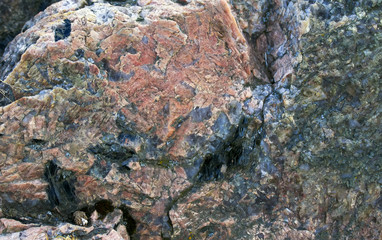 natural granite background with a rough texture of stone with different colored patches