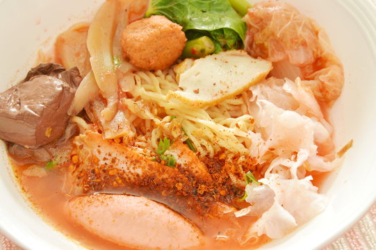 yellow noodles with shrimp and fish ball in red soup Chinese-language called Yong Tau Fu