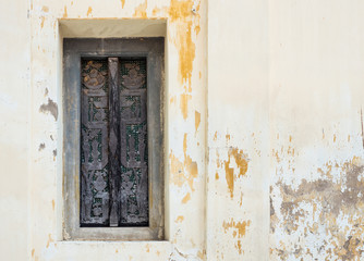 Old wooden window with the carved patterns.
