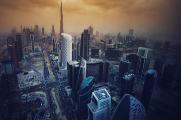 Architecture of a big modern city in dramatic light. Aerial view over the skyscrapers of downtown Dubai, United Arab Emirates. Stylized skyline.