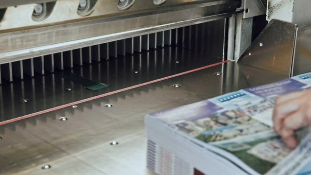 Printing factory - big industrial cutter for cutting paper shears - guillotine machine - close up
