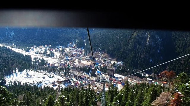 Descent from the slope in the gondola cable car. Accelerated shooting. Dombay