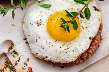 top view of fried egg over hamburger
