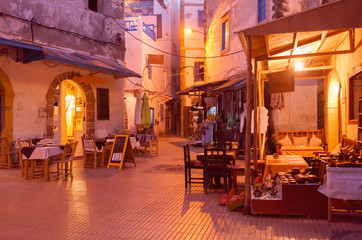 Fototapeta na wymiar Old shopping street in Medina at the evening. Essaouira, Morocco