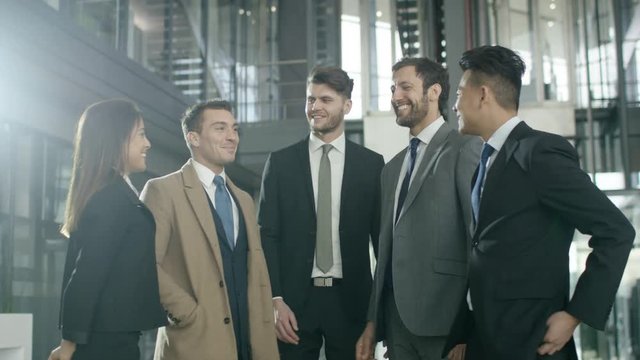  Portrait smiling diverse business group in large modern office building