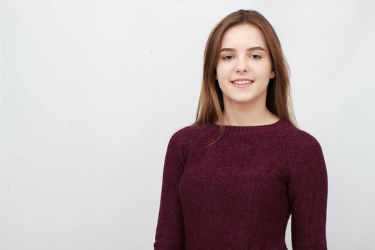 Portrait Of A Young Attractive Woman In Red Sweater