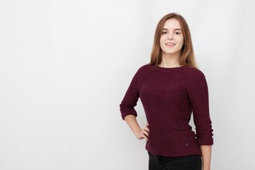 Portrait of a young attractive woman in red sweater