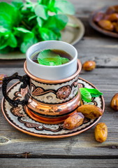 Obraz na płótnie Canvas Tea with mint in arab style on wooden table.