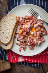 Pieces of sausage fried with egg.