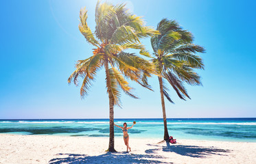 Obraz na płótnie Canvas Young woman on beach cheerful joyful coconut palm trees. Beach Caribbean Sea, Cuba