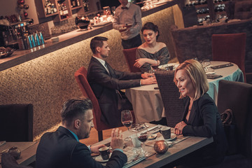 Stylish wealthy couple in a restaurant.