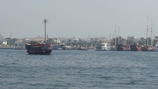 Tourist's Rented Dhow (Small Wooden Ship) Sailing in Dubai Creek
