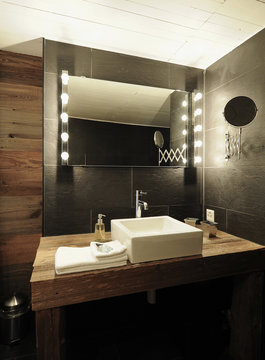 Wood and white designer bathroom in an old renovated chalet