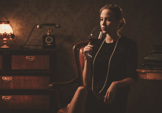 Beautiful Woman With Glass Of Wine In Retro Interior