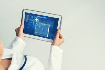 Close of female doctor hands working with tablet pc computer