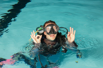 scuba diving course pool teenager girl with instructor 
