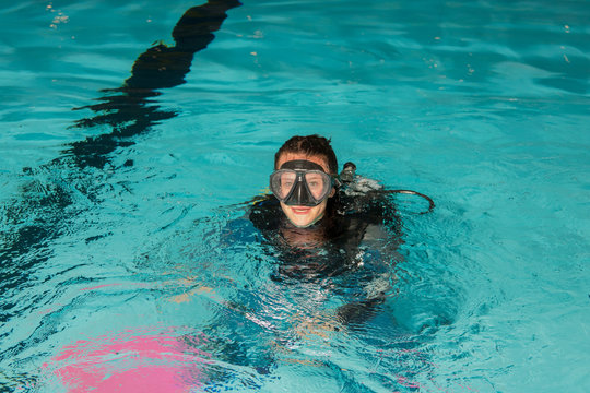 scuba diving course pool teenager girl with instructor 
