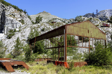 Abandoned marble quarry and rusty steel framework near Carrara, Italy
