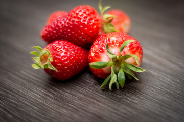 Fresh strawberries on a wooden background.
