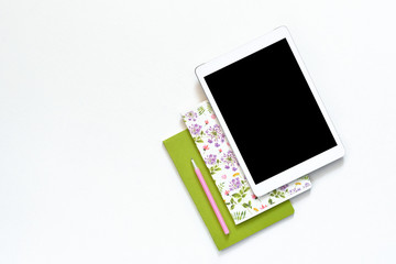 Flat lay photo of office white desk with tablet and green floral ornament notebook copy space background