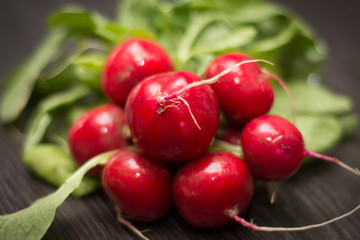 Fresh radishes on wooden table.