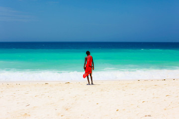 masai on a beach and blue sea Zanzibar, Tanzania - obrazy, fototapety, plakaty