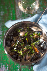 Mussels in sash in saucepan on boards