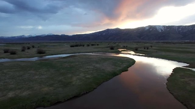 Panning view from drone of sunrise over river