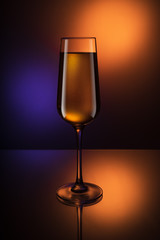 Glass Goblets on a colored background with color liquid and with reflection