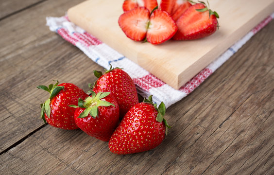 Fresh strawberries on wooden table.
