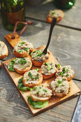 crispy open-face sandwiches with mutabal topping on the cutting board