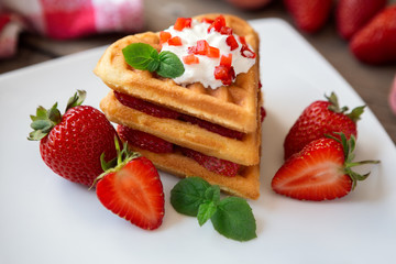 waffles with whipped cream and strawberries.