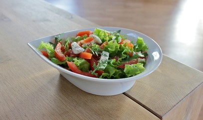 Bowl with Italian caprese salad with lettuce, mozzarella  and tomato