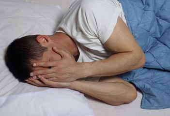 Fototapeta na wymiar Sleep Disorders and Problems. Man struggling with insomnia.