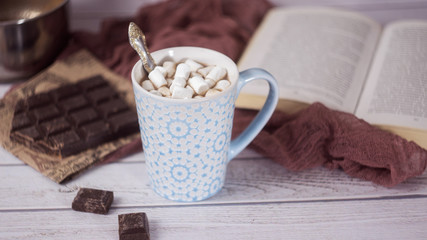 Hot chocolate or cocoa in glass with whipped cream and pieces chocolate