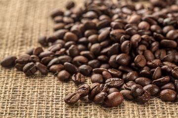 Coffee beans on sacking background
