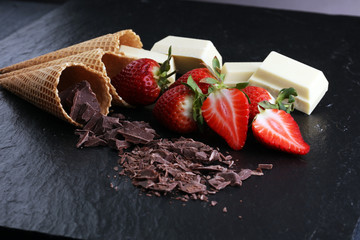 ice cream cones with white chocolate block and dark chocolate rasp and strawberries