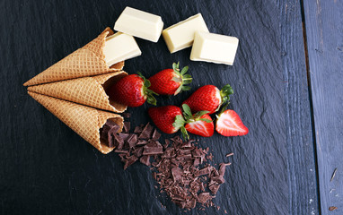 ice cream cones with white chocolate block and dark chocolate rasp and strawberries