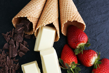 ice cream cones with white chocolate block and dark chocolate rasp and strawberries
