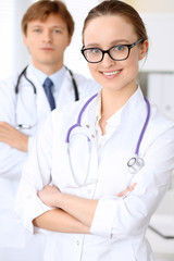 Fototapeta premium Happy doctor woman with medical staff at the hospital