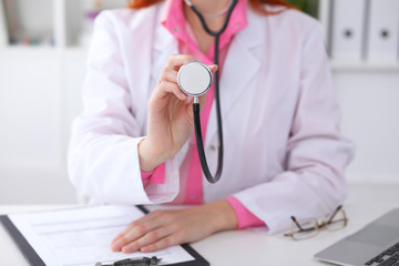 Doctor with a stethoscope in the hands. Pink colored scene