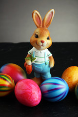 Sugar rabbit and easter eggs on stone grey