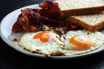 Ham and Egg. Bacon and Egg. Salted egg and sprinkled with black pepper. English breakfast.