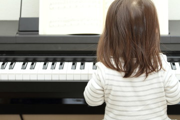 Japanese girl playing a piano (2 years old)