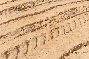 The trail from the tread in the sand. Texture, background