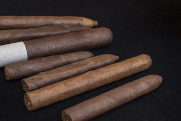 cigars on black background