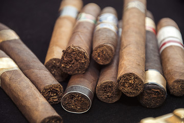 cigars on black background