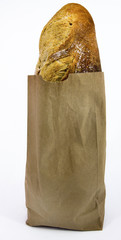 Loaf of San Francisco sourdough French bread in brown paper bag. Isolated. Vertical.